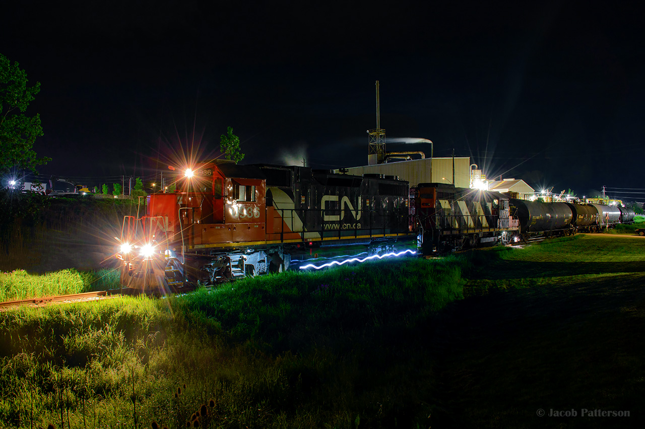 CN L566 has made their setoff and lift at Lanxess in Elmira, and are seen pausing just south of the derail as the conductor walks to the head end.  Time 0152h.  They will arrive back at Kitchener yard in about an hour and twenty minutes.