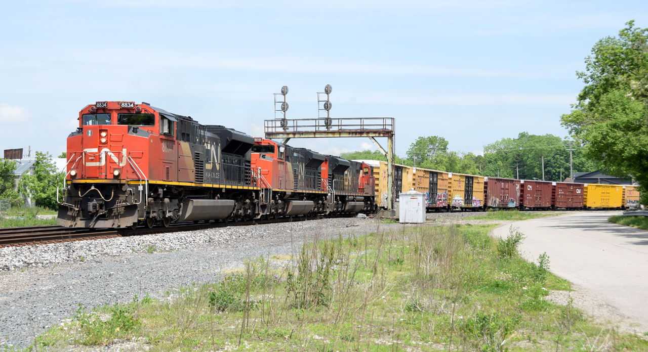 M39731 26 passing under the signal bridge at Paris Jct with CN 8834, CN 8018, CN 8931 and 168 cars