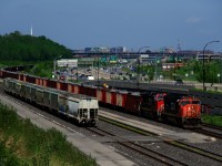 After reloading at the St-Cyrille pit, ballast train CN O491 is heading back west. Here it is about to change crews at Turcot Ouest on a scorching Victoria Day with CN 5713 & CN 2560 for power.