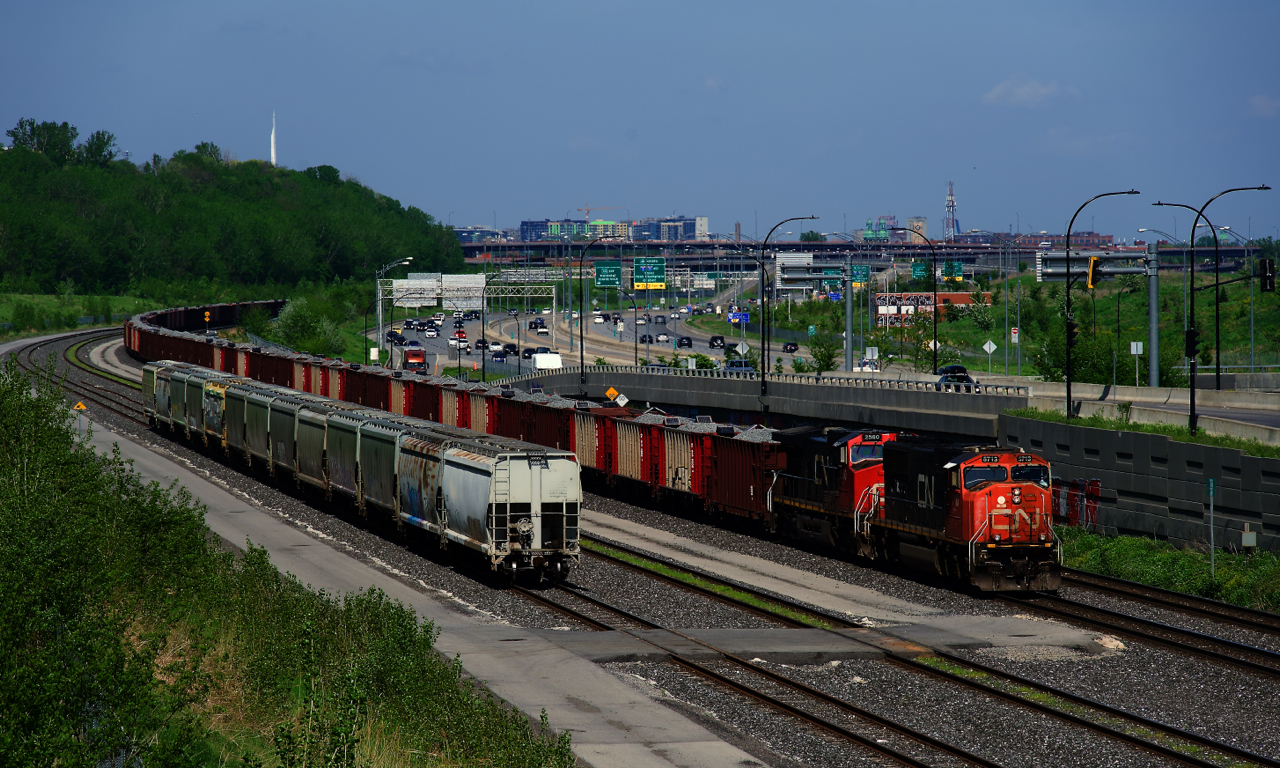 After reloading at the St-Cyrille pit, ballast train CN O491 is heading back west. Here it is about to change crews at Turcot Ouest on a scorching Victoria Day with CN 5713 & CN 2560 for power.