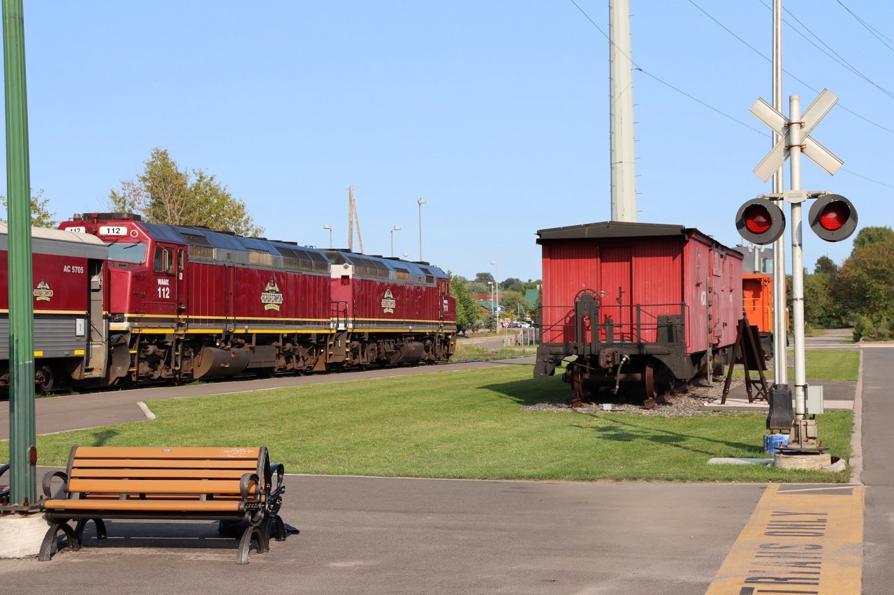 Having arrived back in town after another leisurely excursion to the scenic Agawa Canyon Park, the Agawa Canyon Tour train poses next to a pair of preserved pieces of historic railway equipment - one being an "interpretative" representation of an old railway boxcar that the the Canadian "Group of Seven" artists camped in along the Algoma Central and sketched what would become some of their famous scenic artwork, and the other is a surviving Algoma Central (nee CP) caboose.