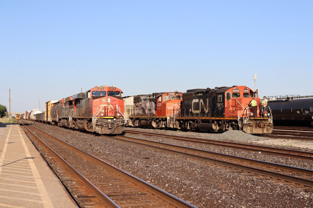 With some track maintenance being performed on the north main, 397 takes the south main to depart Sarnia, ON for Port Huron, MI while the crew of a yard job looks on.