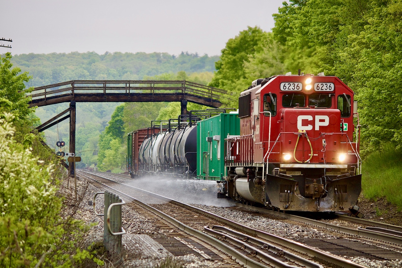 The yearly event. I always look forward to seeing what CP decides to stick on the spray train for power. Definitely lots of variety over the years from SD40’s to SD60’s, CMQ cowls, D&H GP38 and even a rescue UP SD70M last year. This year’s arrival in Toronto would find one SD60 swapped for another SD60, before the train would begin its journey westward toward Windsor. The overcast weather worked well for a morning westbound run, and by mid morning the train was well on its way up the Niagara  Escarpment. Here former SOO Line SD60 6236 has just ducked under the well known wooden farm bridge alongside highway 401  just east of Campbellville.