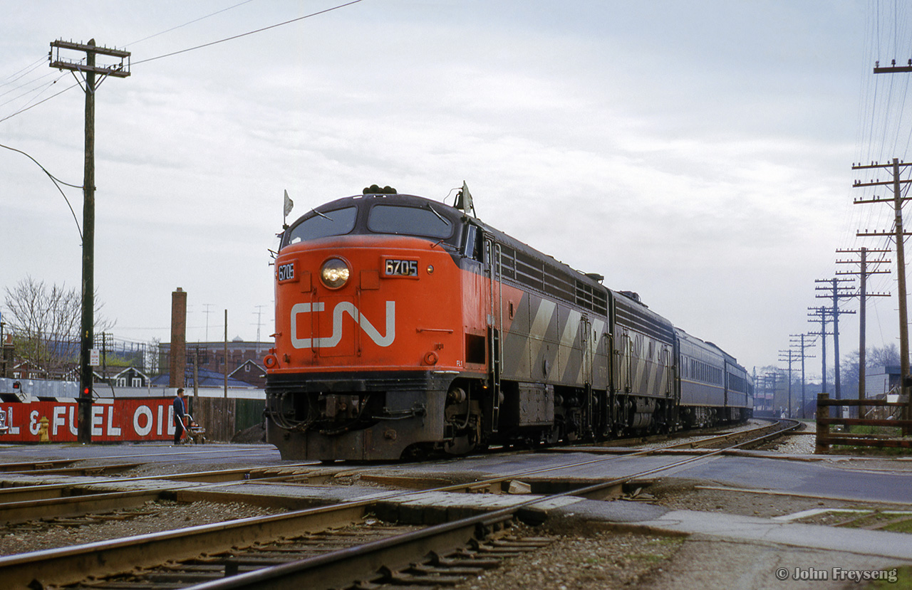 CN CLC C-liner 6705 and a GMD B-unit lead the second section of train 54, the Bonaventure, across Pape Avenue in Danforth.  At left is coal and fuel oil yard number 6 of the Milnes Coal Co. at 354-358 Pape Ave.


Scan and editing by Jacob Patterson.