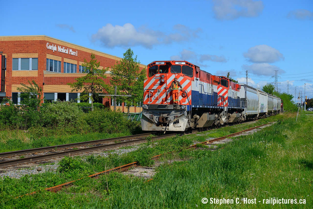 Part 2: Doug Blue watches the point as L542 shoves south on the former CN Fergus Subdivision which was rare mileage for OSR motive power, passing Guelph Medical Place 1 on this beautiful spring morning.