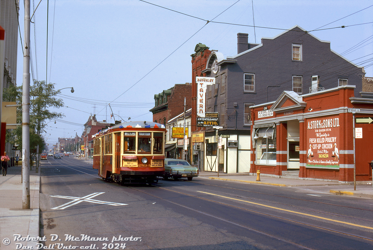 TTC Peter Witt streetcar 2894, operating in Beltline Tour Tram service downtown, heads eastbound on Queen Street West at St. Patricks Square, passing a row of storefronts that include A. Stork & Sons (aptly named for a poultry shop) and the Beverley Tavern. On the left barely visible is 299 Queen Street West, the famed home of CityTV. Most of the buildings here remain today, although somewhat changed.

Robert D. McMann photo, Dan Dell'Unto collection slide.