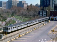 A 4-pack of TTC subway cars heads southbound through the open-cut section of the Yonge Subway line along Alymer Avenue in Rosedale, about to duck back underground at Ellis portal for their next station stop at Bloor/Yonge. The trailing car is H1 5462 (mated sister car 5461), while in the lead are a pair of new H5-series subway cars. For a time, different TTC M- and H-series subway car classes often mixed and ran together.
<br><br>
On the right is the back of Canadian Tire's old store at 839 Yonge St. still a going concern today
<br><br>
<i>Bryce Lee photo, Dan Dell'Unto collection slide</i>