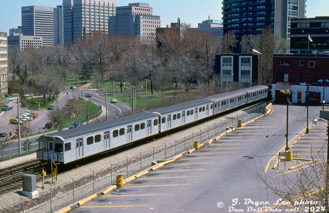 A 4-pack of TTC subway cars heads southbound through the open-cut section of the Yonge Subway line along Alymer Avenue in Rosedale, about to duck back underground at Ellis portal for their next station stop at Bloor/Yonge. The trailing car is H1 5462 (mated sister car 5461), while in the lead are a pair of new H5-series subway cars. For a time, different TTC M- and H-series subway car classes often mixed and ran together.

On the right is the back of Canadian Tire's old store at 839 Yonge St. still a going concern today

Bryce Lee photo, Dan Dell'Unto collection slide