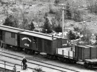 As one example of the astonishing level of detail in the Archibald Murchie glass negative of Keefers recently posted (http://www.railpictures.ca/?attachment_id=54515), consider this extreme crop zoomed in to the group of cars near the depot.

<p>No specific date provided, but Mr. Murchie became photographically active in 1893, so the general era of 1890s reported for that photo is believed accurate.  I wonder, is that Mr. George Alexander Keefer, surveyor and construction engineer during the Onderdonk era, and namesake of that CP station, standing on the platform with a rifle and a child and a dog?