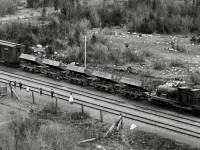 As a second example of the astonishing level of detail in the Archibald Murchie glass negative of Keefers recently posted (http://www.railpictures.ca/?attachment_id=54515), consider this extreme crop to another group of cars near the depot.

<p>Probably stored tipped to avoid accumulating precipitation, those side-dump cars are something never seen before, simple predecessors of the air-dumps common today.

<p>The nine people facing the camera are likely a significant part of the population of Keefers, which was probably still known as Keefer’s in those days.