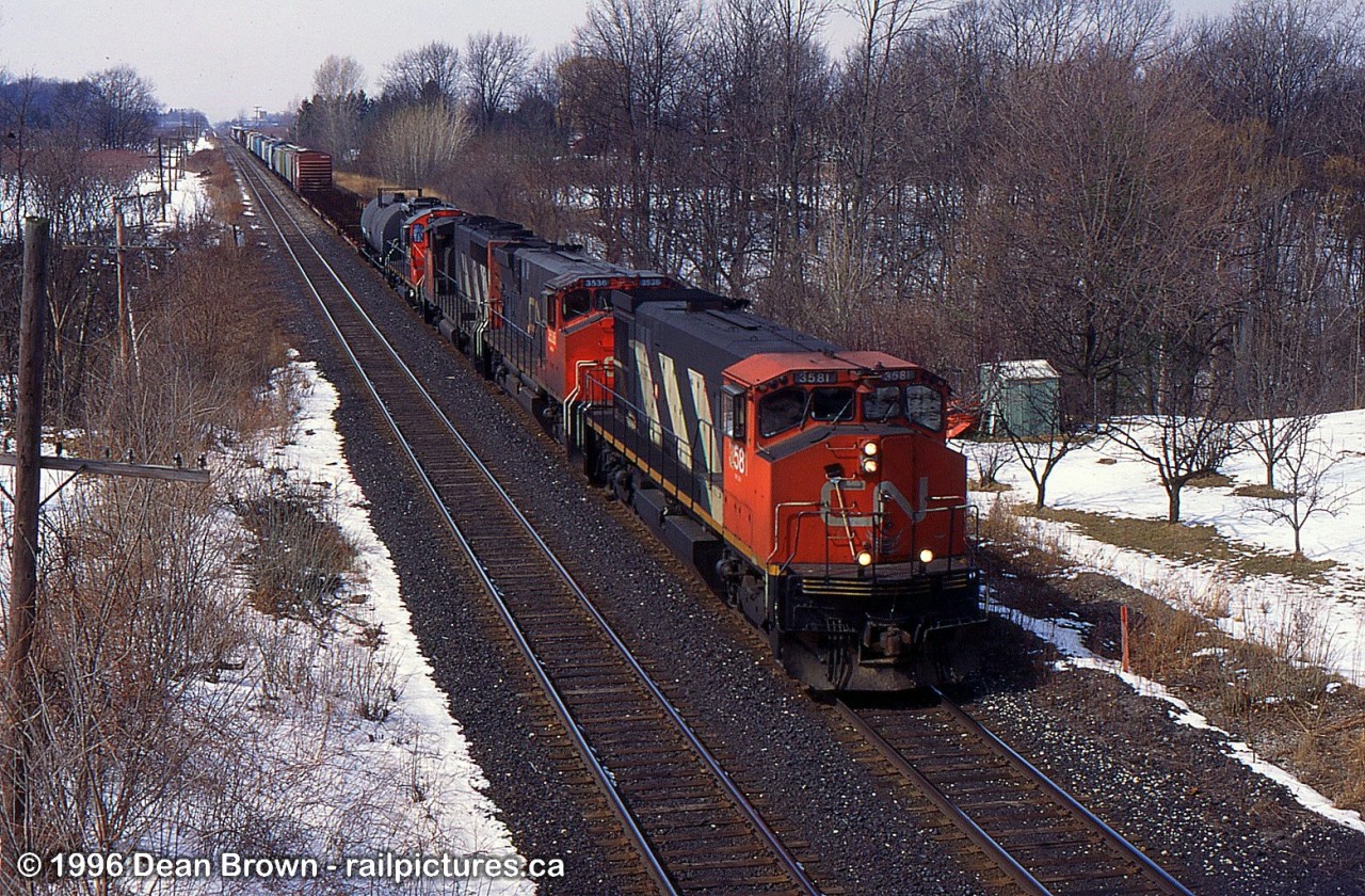 CN 3581 leads 449 through Jordan on the CN Grimsby Sub at 13th Street overpass in 1996.