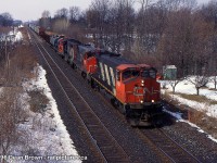 CN 3581 leads 449 through Jordan on the CN Grimsby Sub at 13th Street overpass in 1996.