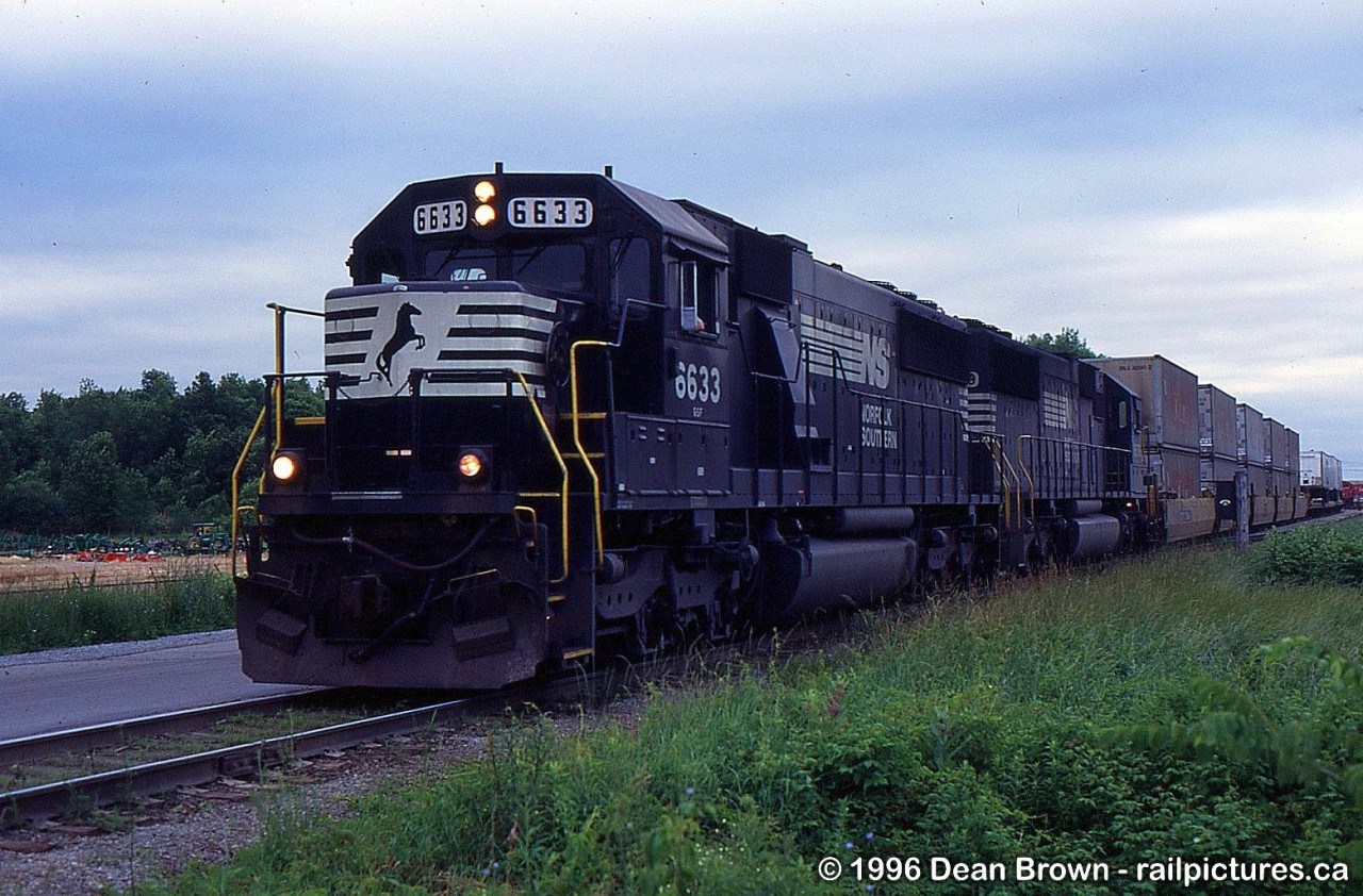 NS 6633 leads NS 445 Departing Dain City in the evening around 18:30 bound for Buffalo onto the Canal Sub to Feeder, the Cayuga Sub to Robbins, and the CN Stamford Sub to Fort Erie and Buffalo.