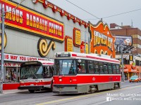 Honest Ed's. During a charter on August 15, 2010, soon to be retired TTC 2345 (T6H-5307N, GMDD, 1982-1983) was posed by the famous store "Honest Ed's" with its 23,000 exterior light bulbs on Bathurst and Bloor in Toronto, Ontario as TTC CLRV 4036 (Hawker Siddeley, 1977–1981) passed by on the Route 511. From 1948-2016, this discount store served with slogans like "Not cheaper anywhere else in Toronto!", "Come in and get lost!" and "Only the floors are crooked!".  Founder Ed Mirvish died in 2007, but the memory of him and his store are preserved in the neighborhood. Both the CLRV and ALRV fleet were retired by the end of 2019, making this scene now completely different. Examples of the legacy Hawker Siddeley streetcars are preserved at the Halton Radial, Illinois Railway, and Seashore Trolley Museums.