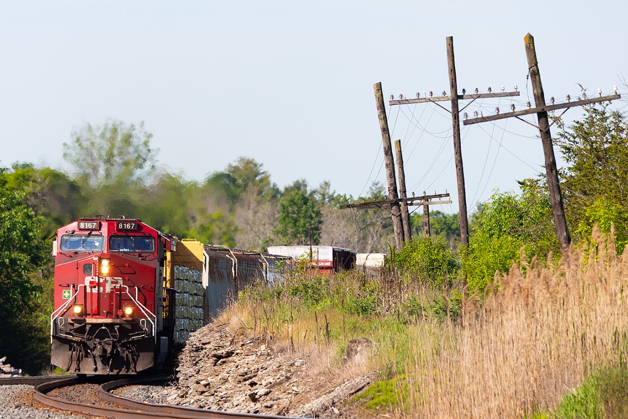 With under 2 hours to go until Smiths Falls and a crew change, CP 8167 rounds the curve at Lonsdale leaving the farmland behind and entering the more rugged landscape of eastern Ontario.