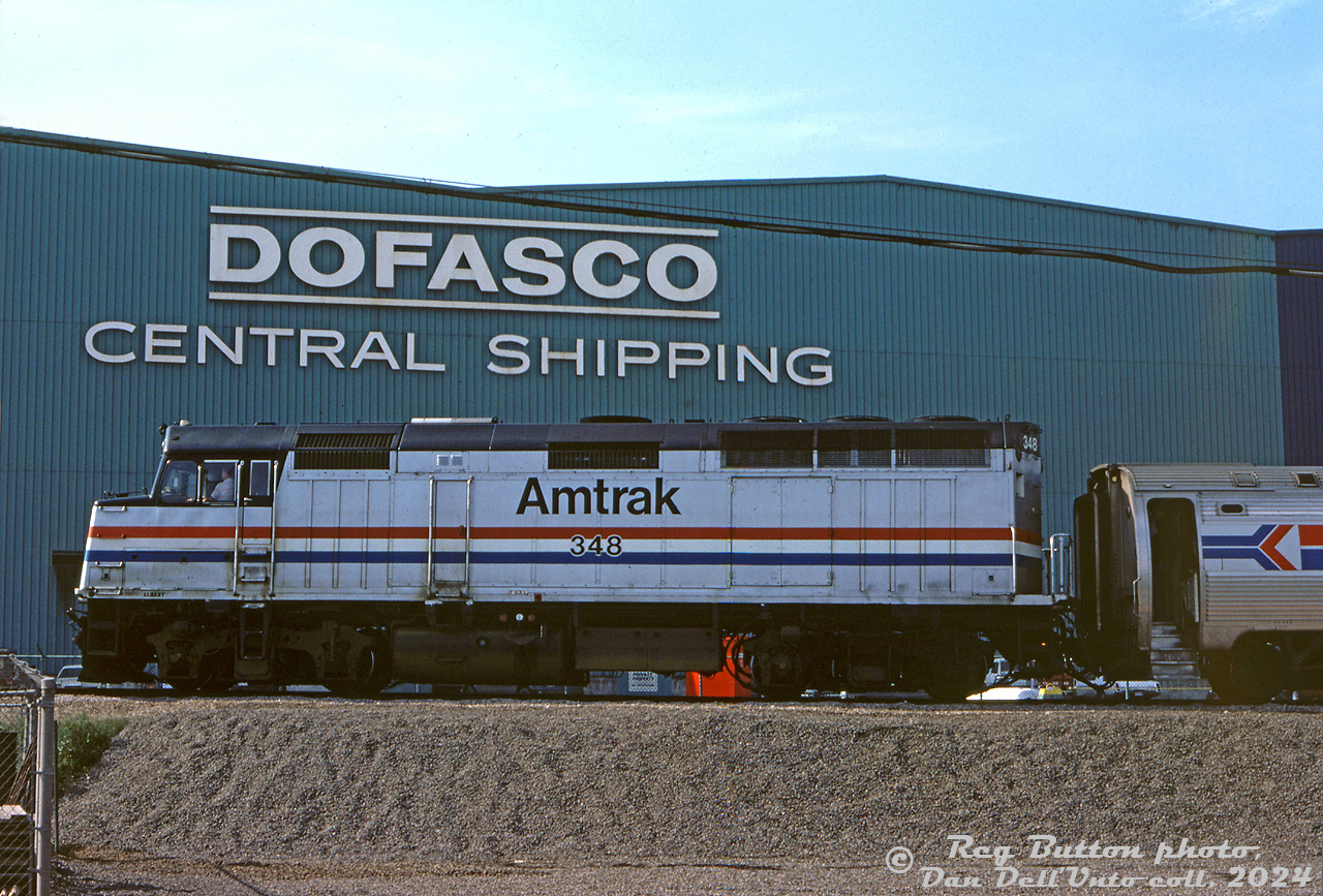 Due to a derailment at the time on the CN Grimsby Sub, Amtrak had to detour through the Hamilton industrial area to get by. Here, Amtrak F40PH 348 leads #96 "The Maple Leaf" along Brampton Street near Strathearne, past the large Dofasco Central Shipping sign.

Reg Button photo, Dan Dell'Unto collection slide.

View of the train approaching: http://www.railpictures.ca/?attachment_id=45342
Another Amtrak detour the next day: http://www.railpictures.ca/?attachment_id=49005