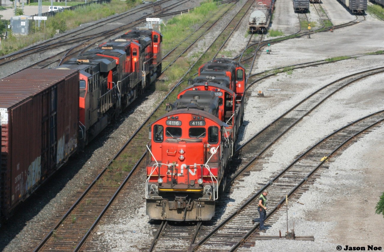 CN 422 passes Stuart Street Yard in Hamilton, Ontario as CN GP9RM’s 4116, 7052 and 7016 prepare to switch out another cut of cars in the yard.