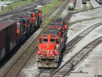 CN 422 passes Stuart Street Yard in Hamilton, Ontario as CN GP9RM’s 4116, 7052 and 7016 prepare to switch out another cut of cars in the yard.