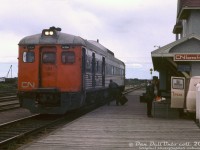 While CP/VIA's Calgary-Edmonton "Dayliner" RDC service was the most well-known in Alberta, from 1956 and into the 1970's CN also operated "Railiner" passenger services in Alberta using Budd RDC cars. One service ran between Edmonton and Calgary (over the ex-GTP line, mainly the CN Camrose Sub), and another between Drumheller and Calgary (over the Stettler Sub, ex-CNoR), both running via Camrose. There were also other Railiners running between Edmonton and North Battleford SK, and Edmonton and Grand Centre.<br><br>The Edmonton-Calgary and Edmonton-Drumheller Railiners had a neat operating arrangement, typical of small prairie branchline railroading: at Camrose station, the RDC from Drumheller or Calgary would arrive and lay over, waiting for the other train to arrive. Once both showed up at the station, the two Budd cars would be coupled together and run as a single, combined train for the final run from Camrose to Edmonton. The proceedure was done in reverse when both left Edmonton together, and one Budd would branch off from Camrose to Drumheller, while the other would continue on to Calgary.<br><br>Here, CN RDC-3 6356 has arrived at Camrose station from Calgary, and awaits the Drumheller train that has yet to arrive. While laying over, the car takes on baggage through one of its doors, and passengers grab a snack at the coffee van waiting outside the station. Soon the Drumheller run with RDC-1 6114 will show up, and both Budds will be coupled together for their departure to Edmonton.<br><br>CN RDC-3 6356, formerly CN D356 that was acquired from the Chesapeake & Ohio (and originally built for Missouri-Kansas-Texas as their only RDC, 20) was the only RDC in CN's fleet to feature end and vestibule door fluting. By 1971 however, the front A-end of 6356 had lost its fluting (possibly after a grade crossing accident or other incident). The car still retained its door and B-end fluting though.<br><br>There's not too much information on these CN operations online. Research shows CN applied to discontinue the Edmonton-Calgary run in 1971 due to competition from the highway and private automobile, while the Edmonton-Drumheller run lasted until late 1981 under VIA. VIA ran the former CP Edmonton-Calgary RDC service until cancellation in September 1985, and that was it for passenger rail service between Alberta's two largest cities.<br><br>CN's Camrose station, once located at the east end of town, was moved and preserved by the local railway historical society. CN 6356, sold to VIA and later rebuilt as RDC-2 6221, was one of the casualties of the IRSI bankrupcy and was cut up for scrap in 2016.<br><br>Original photographer unknown (possibly E.W.Johnson), Dan Dell'Unto collection slide.