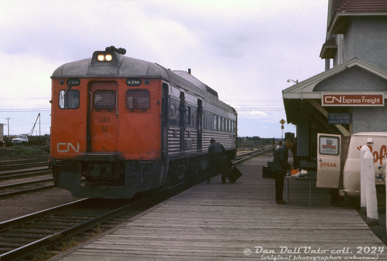 While CP/VIA's Calgary-Edmonton "Dayliner" RDC service was the most well-known in Alberta, from 1956 and into the 1970's CN also operated "Railiner" passenger services in Alberta using Budd RDC cars. One service ran between Edmonton and Calgary (over the ex-GTP line, mainly the CN Camrose Sub), and another between Drumheller and Calgary (over the Stettler Sub, ex-CNoR), both running via Camrose. There were also other Railiners running between Edmonton and North Battleford SK, and Edmonton and Grand Centre.

The Edmonton-Calgary and Edmonton-Drumheller Railiners had a neat operating arrangement, typical of small prairie branchline railroading: at Camrose station, the RDC from Drumheller or Calgary would arrive and lay over and wait for the other train to arrive. Once both showed up at the station, the two Budd cars would be coupled together and run as a single, combined train for the final run from Camrose to Edmonton. The proceedure was done in reverse when both left Edmonton together, and one Budd would branch off from Camrose to Drumheller, while the other would continue on to Calgary.

Here, CN RDC-3 6356 has arrived at Camrose station from Calgary, and awaits the Drumheller train that has yet to arrive. While laying over, the car takes on baggage through one of its doors, and passengers grab a snack at the coffee van waiting outside the station. Soon the Drumheller run with RDC-1 will show up, and both Budds will be coupled together for their departure to Edmonton.

CN 6356, formerly CN D356 that was acquired from the Chesapeake & Ohio (and originally built for Missouri-Kansas-Texas) was the only RDC in CN's fleet to feature end and door fluting. By 1971 however, the front A-end of 6356 had lost its fluting (possibly after a grade crossing accident or other incident). The car still retained its door and B-end fluting though.

There's not too much information on these CN operations online. Research shows CN applied to discontinue the Calgary-Drumheller run in 1971 due to competition from the highway and private automobile, while the Edmonton-Drumheller run lasted until late 1981 under VIA. VIA ran the former CP Edmonton-Calgary RDC service until cancellation in September 1985, and that was it for passenger rail service between Alberta's two largest cities.

CN's Camrose station, once located at the east end of town, was moved and preserved by the local railway historical society. CN 6356, sold to VIA and later rebuilt as RDC-2 6221, was one of the casualties of the IRSI bankrupcy and was cut up for scrap in 2016.

Original photographer unknown (possibly E.W.Johnson), Dan Dell'Unto collection slide.