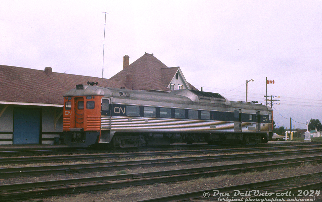 Another view of the Edmonton-bound CN "Railiner" from Calgary, handled by RDC-3 6356, sitting at the station at Camrose awaiting arrival of the Drumheller RDC. It will soon move to a siding south of the station, allowing CN RDC-1 6114 arriving from Drumheller to make its station stop. 6356 will then pull in behind 6114, and the crews will couple both units together for the combined final run from Camrose to Edmonton.

CN RDC-3 6356 was originally built for the Missouri-Kansas-Texas as 20, their only RDC. It featured optional end and vestibule door fluting, an option a few railroads opted for (PGE being another). MKT 20 was later renumbered 162, and sold to the Chesapeake & Ohio in June 1962 as their 9082. A few years later, C&O sold the car to CN in August 1965, where it became their D-356 before being renumbered by CN to 6356 in 1969. When initially acquired by CN, the car still retaining fluting at both ends, but by 1971 it had lost its A-end fluting after an accident or other incident (the B-end fluting, still intact, is shown here).

It became VIA 6356 in 1978, and eventually rebuilt with a smaller baggage area (likely by CN at Pointe St. Charles shops) as VIA RDC-2m 6221 in March 1983. Sometime during its career as 6221, the B-end fluting was removed (but its door vestibule fluting was still retained). Some sources show it as retired in 1990 and stored until being sold to Industrial Rail Services (IRSI) in 2000, one of a large group of RDC cars IRSI acquired in hopes for rebuilding/refurbishing them for possible buyers. It was not rebuilt, and due to IRSI's financial difficulties in the mid-2010's, it was scrapped sometime in 2015-2016 along with most of IRSI's RDC inventory.

Original photographer unknown (possibly E.W.Johnson), Dan Dell'Unto collection slide.

Initial view of CN 6356 at Camrose: http://www.railpictures.ca/?attachment_id=54598