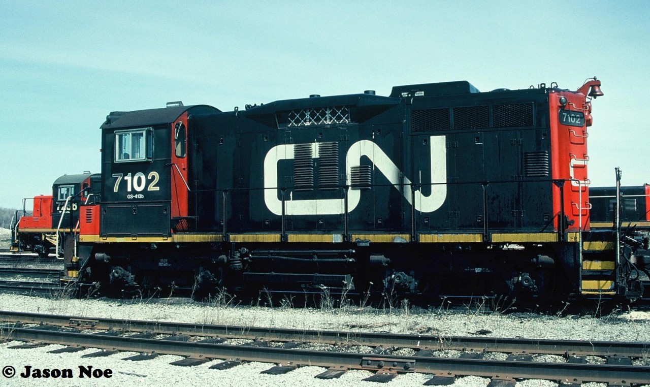 CN SW1200RSm 7102 and GP9RM 7256 are viewed at the MacMillan yard diesel shop in Vaughan, Ontario awaiting their next assignments. 7102 is ex-CN SW1200RS 1230 and 7256 is ex-CN GP9 4330.