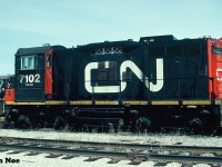 CN SW1200RSm 7102 and GP9RM 7256 are viewed at the MacMillan yard diesel shop in Vaughan, Ontario awaiting their next assignments. 7102 is ex-CN SW1200RS 1230 and 7256 is ex-CN GP9 4330. 