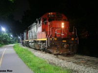 CN L566 with GP38-2 4716 and GP9RM 7038 are viewed waiting near William Street in Waterloo, Ontario for their yellow signal to proceed north on the ION portion of the Waterloo Spur to Elmira. 