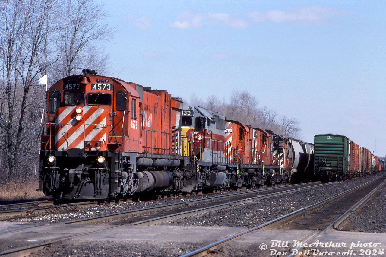 Late 80's leased and MLW power: a westbound extra freight works the west end of Guelph Junction with plenty of power up front: CP M630 4573, leased Algoma Central Railway SD40-2 183 (a damaged numberboard making it look like 133), RS18's 8765 and 8791, and SW1200RS 8161 (one of the old GRR-assigned regulars).

Bill McArthur photo, Dan Dell'Unto collection slide.