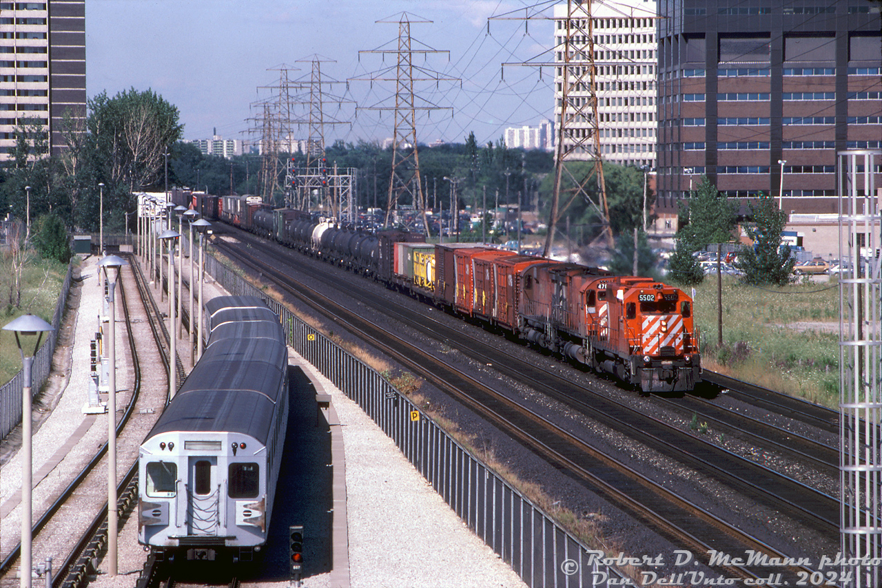 A meet of sorts: CP SD40 5502 leads two big M's on a westbound freight (with auto parts and intermodal traffic on the head end) heading through Obico on CP's Galt Sub, passing a train of TTC Hawker Siddeley H5's heading eastbound on the Bloor-Danforth line after departing Kipling Subway Station.

Robert D. McMann photo, Dan Dell'Unto collection slide.