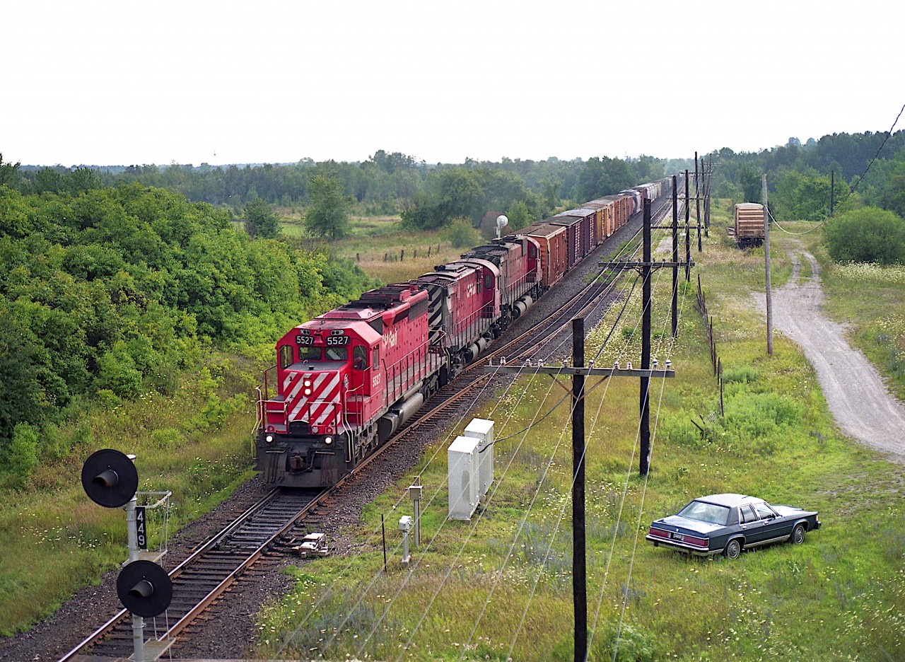As seen from the Hwy 6 bridge over the Galt sub; CP 5527, 4201 (MLW C-424) and 4705 (MLW M-636) as train #504 makes its way eastward. My car is parked on where once was the location of the Puslinch station, many years removed. Nice variety of power, now gone from the roster. CP SD40 5527 ended up on the Indiana Northeastern and the trailing MLWs are  retired.