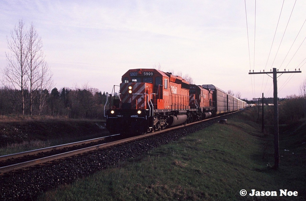 A late evening eastbound CP train is seen crossing over the Nith River in Ayr, Ontario on the Galt Subdivision with SD40-2 5909 and recently reactivated M-636 4743.