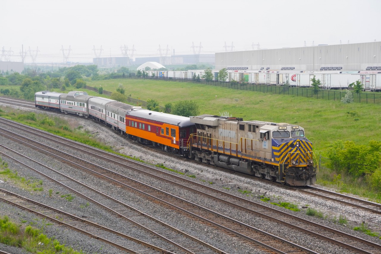 After being dropped off at the West end of the Malport service tracks from Chicago on Z148, what I assume is a 500 puller crew bringing what appear to be some leased passenger cars with CN wraps and all with "ZERO is Possible Stickers" bound for Halifax along with CN 3941 unto the North service track before backing into BIT to be put on Z120 later that night. The first car is painted in the Milwaukee Road scheme, the second is an ex-NYC car called "Swift Stream", third appears to be a classic CN one with the name "White Bear Lake", fourth is a dome car built for Western Pacific's California Zephyr with the name "Silver Palace" and the last one is a repainted heavyweight baggage car. The last 4 having RXCX reporting marks.