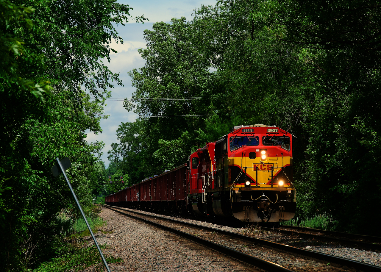 An empty ballast train from Maine is on the Farnham Connection as it makes the turn from the Adirondack Sub to the Vaudreil Sub. It will leave its cars at Lachine IMS Yard, to be picked up by CPKC 113 later that night. Power is a KCS SD70MAC and a CP SD30C-ECO.