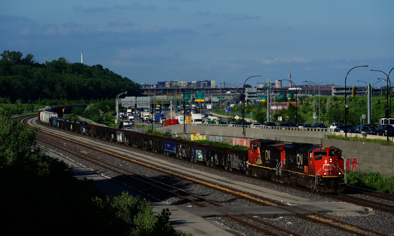 CN 321 has gons up front as it rounds a curve.