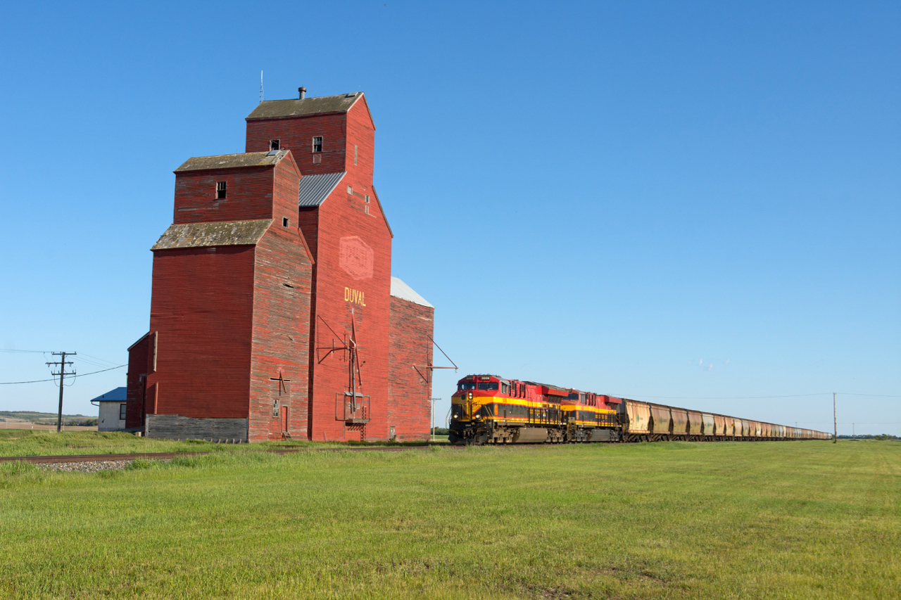 Northbound potash empties make their way up the Lanigan Sub past the old red elevator at Duval. Up front are KCS 5008 and 4825, with KCS 4124 on the tail end.