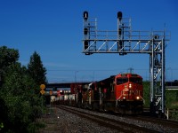 CN 120 is passing underneath a signal gantry with four GEs up front.