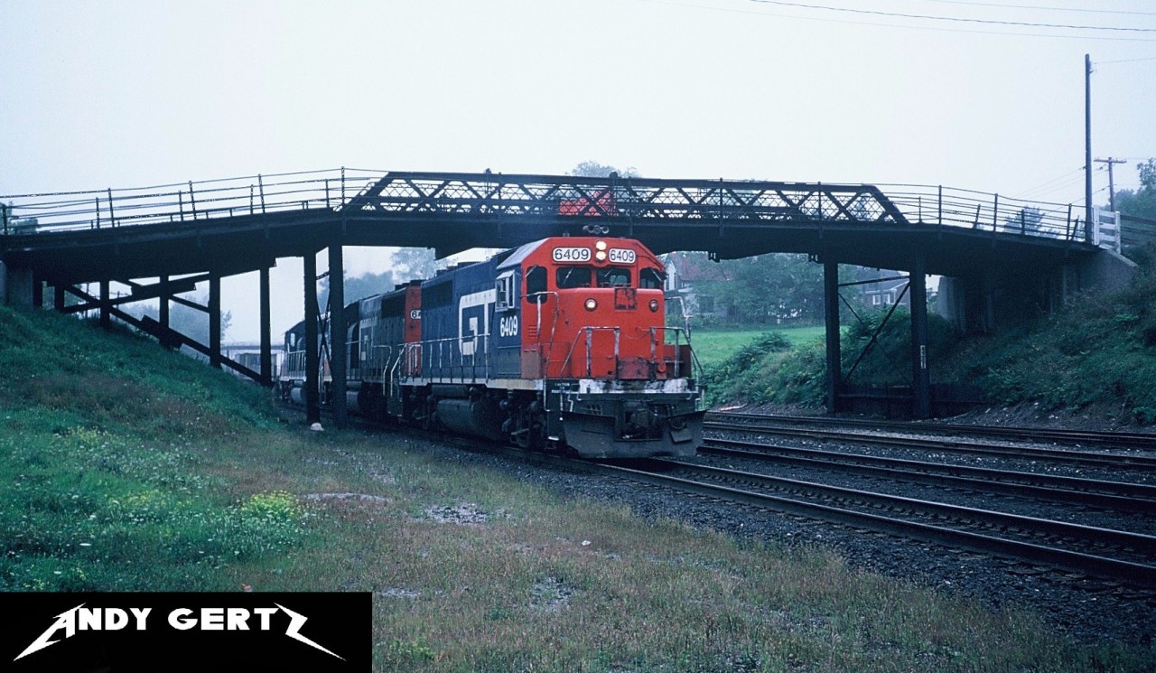 GTW GP40-2 6409 leads a solid set of GTW power on an eastbound intermodal train through Woodstock, Ontario approaching the Woodstock station.