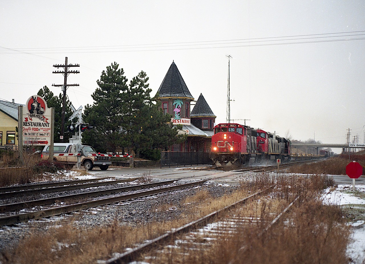 Light dusting of snow, but a rather cold morning.  Here we see CN #333 with CN 9663, 2414 and 5082 heading eastward toward Niagara Falls. The beautiful Grimsby station was now home to the RailHouse restaurant which came into being after the Grimsby Depot concept, which was a few businesses and restaurant operating out of some rolling stock west of the station, failed due to lack of customer base. The station itself would perish in an electrical fire on the last day of 1994. Not at all knowing I would relocate from St. Kitts to Grimsby some years later, I'm really glad I took the time to photograph this most picturesque location while it lasted.