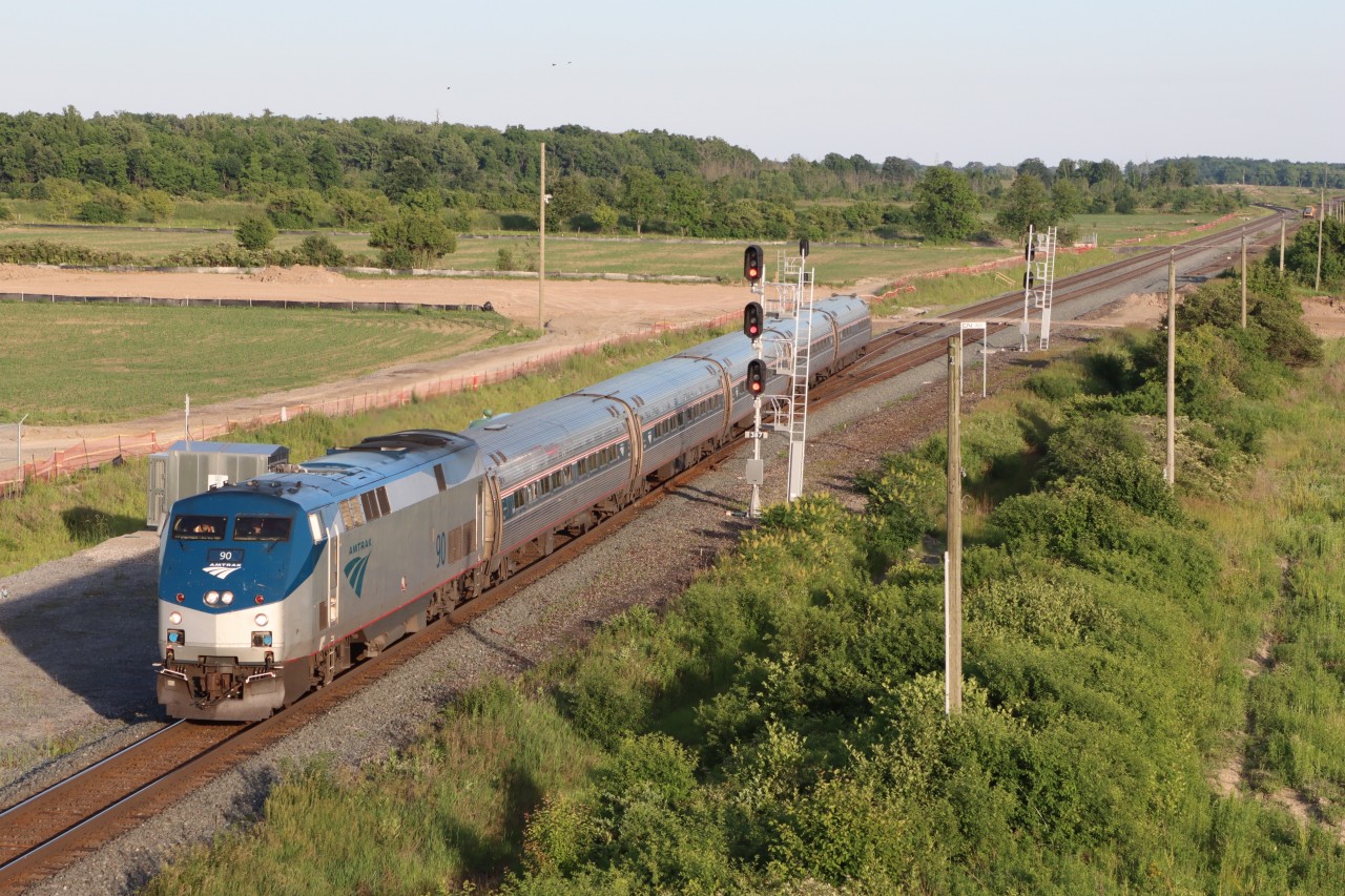 Amtrak Maple Leaf operating as V98 with AMTK 90 at Ash, Mile 38.7 Halton Sub.. Planned preparation work by Metrolinx for the Burloak Drive grade separation project and other maintenance tasks on the Metrolinx portion of the Oakville Sub. between Kerr St. and Burlington West has all VIA trains detouring via the Halton Sub. this weekend.