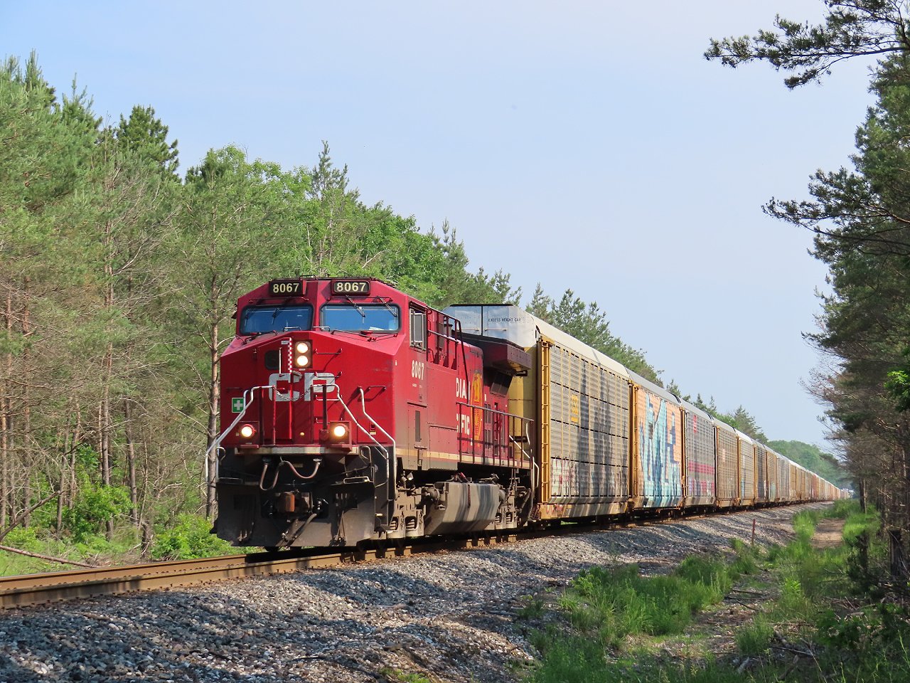 A solid autorack train is holding just north of the Highway 26 crossing in Midhurst. About an hour later they got underway again.