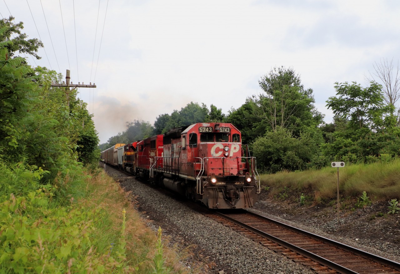 I was sitting here watching the Nascar race, when I got a text of a westbound CP coming my way, so off I went to wait it out. I sat in my usual spot watching the birds and deer for twenty-five odd minutes, when on came the red signals at mile 42 saying the train was in the block. I got in position to wait it out. The horn sounded as it approached the fourteenth concession and it sounded a bit funny. In to view comes SD40-2, CP 5743 with CP 2283 and KCS 4127 leading what I was later told was CPKC 135. An SD40-2 leading was a great surprise. The only thing missing was a bit of sun but at 7:41pm, I'll take what I got.