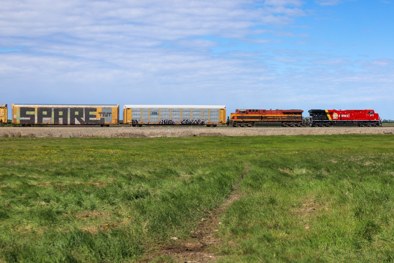 CP 9375 and KCS 4858 cruise through the country side north of Millet, Alberta.  CP 9375 is sporting the new CPKC paint scheme.