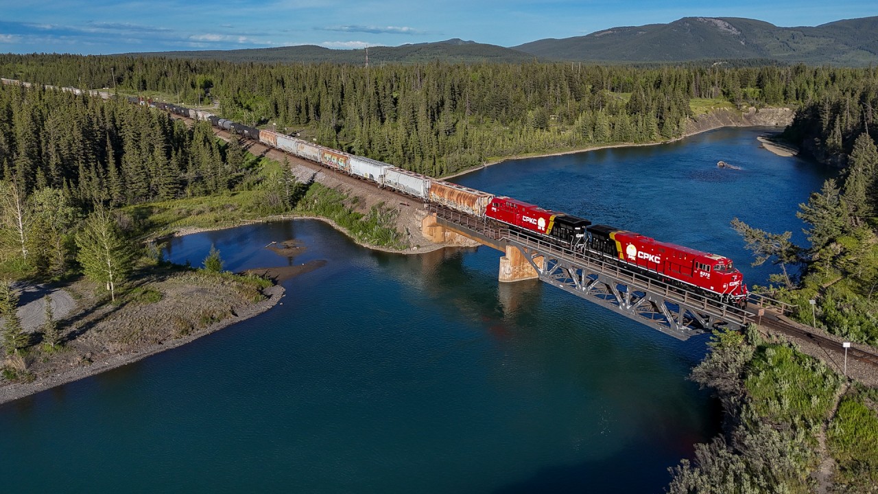 CP 401-14 crosses the Kananaskis River, as they leave the foothills behind and start their ascent towards the Continental Divide.