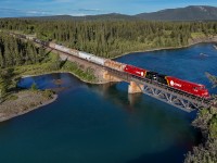 CP 401-14 crosses the Kananaskis River, as they leave the foothills behind and start their ascent towards the Continental Divide. 