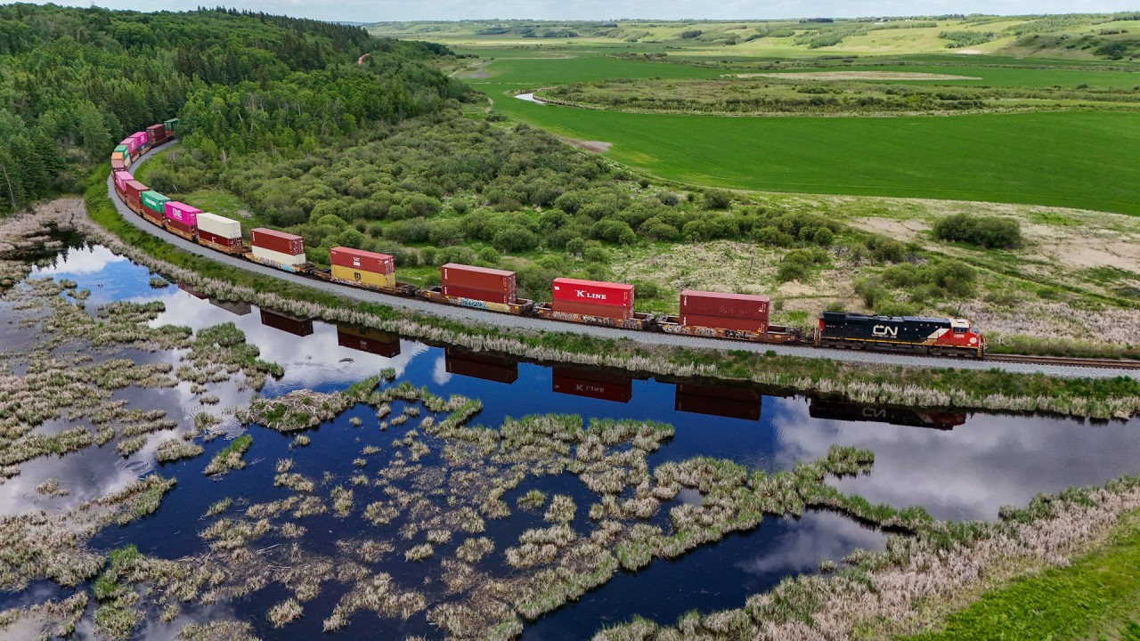 X 14451 17 climbs out of the Battle River Valley, at Ferlow Junction where the Stettler Sub, connected with the Camrose Sub.  If you look closely at the bottom right frame, you can see part of the old right of way.