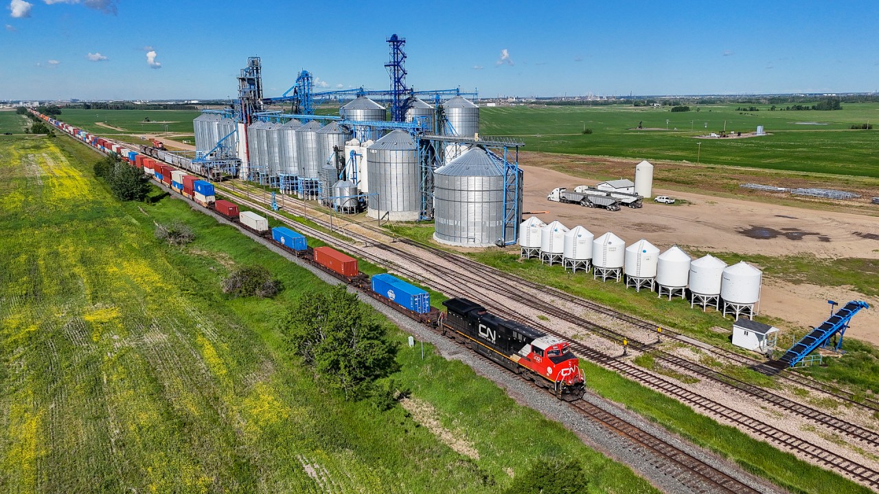 When the Mega Gangs hit the Wainwright Sub, several mainline trains a day will detour across the Prairie North Line between Edmonton and Saskatoon.  Here we see Q 19251 16 on the Vegreville Sub, passing the Providence Grain Group elevator, at Gaudin, Alberta.