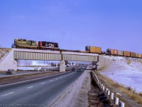 Extra 4494 west takes the curve over the 401 with traffic for CN's Toronto Yard.  A part of the Toronto bypass project during the mid 1960s, the York Sub opened just two years earlier in 1965.  See <a href=https://www.railpictures.ca/?attachment_id=45009>Phil Hall's 2021 photo of the bridge,</a> expanded over the years.<br><br><i>John Freyseng Photo, Jacob Patterson Collection Slide.</i>