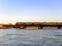 CN <i>Rapido</i> 64 throttles up rounding the curve through Trenton Junction, crossing the Trent River en route to Montreal. <br><br><i>Scan and editing by Jacob Patterson.</i>