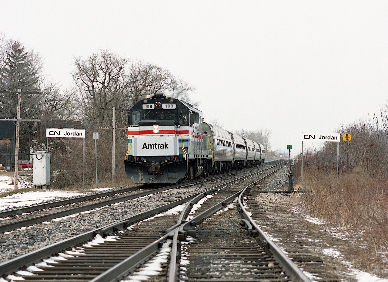 A typical dull winter-grey sky on the morning of March 14, 1992 and I went down to Jordan to catch AMTK #97. Nice to see it #198, the former GO Transit #506, one of 8 GO GP40TC locomotives sold to Amtrak in 1988. Here, it still looks rather spiffy in its new paint. All eight (192-199) were rebuilt to GP38H-3 by the NS in 2005. I don't remember when the track and switch on the right was removed, but I do recall a small yard here at one time as Jordan was once a very busy location for fresh fruit shipping.